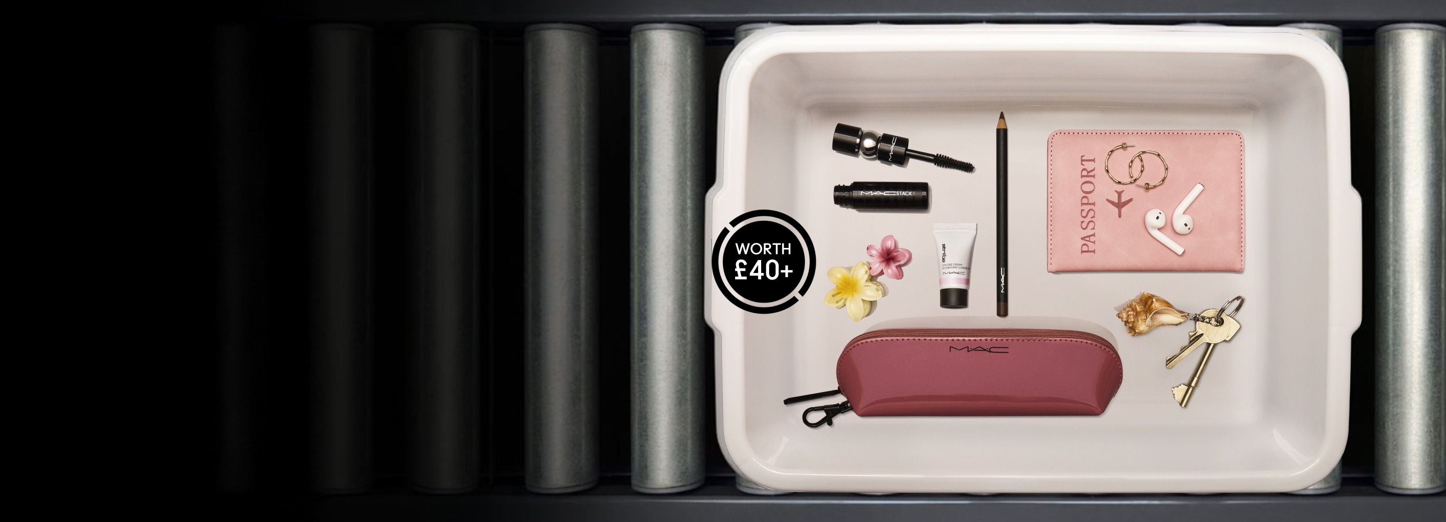 free gifts; eye pencil, mini mactsack, strobe and makeup bag in airport tray