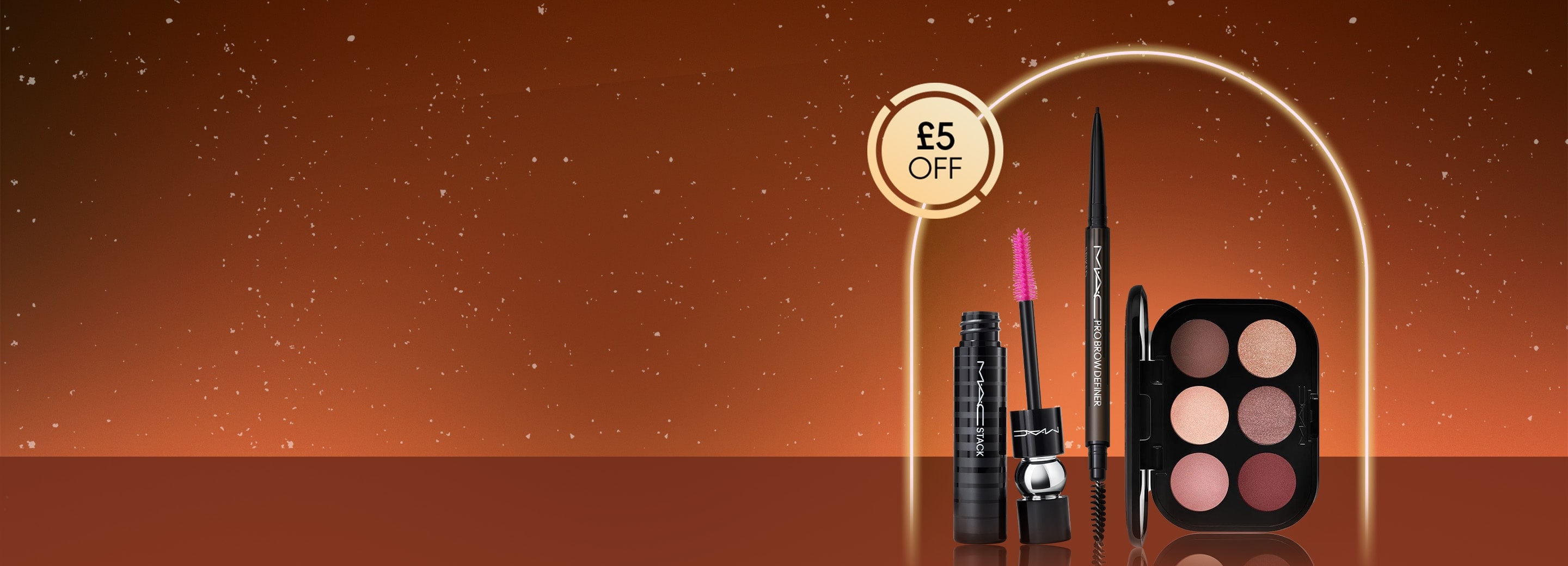 mac eye makeup products on a orange background