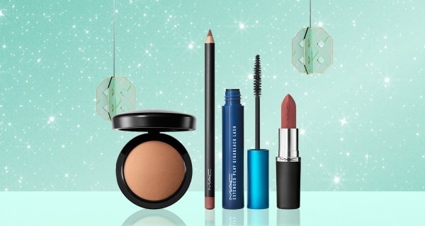 Makeup products on sparkly mint background