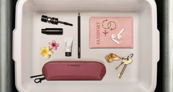 free gifts; eye pencil, mini macstack, strobe cream and bag on a airport tray