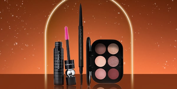 mac eye makeup products on a orang background