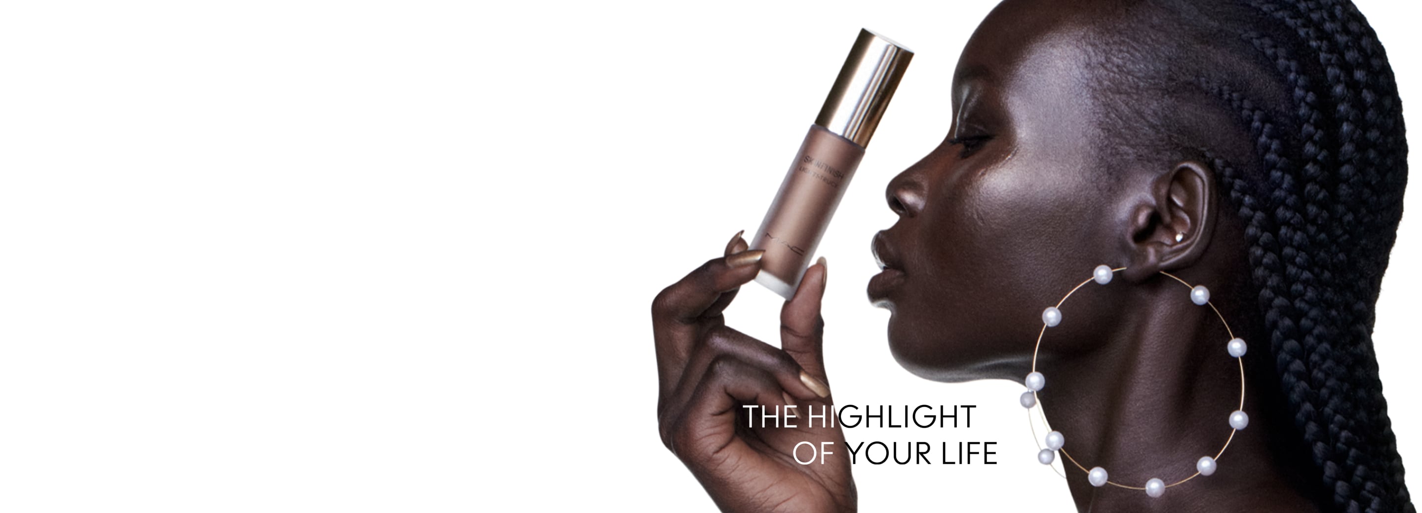 Black model holding MAC Skinfinish Lightstruck Liquid Highlighter