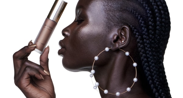 black model holding new MAC skinfinish lightstruck liquid highlighter