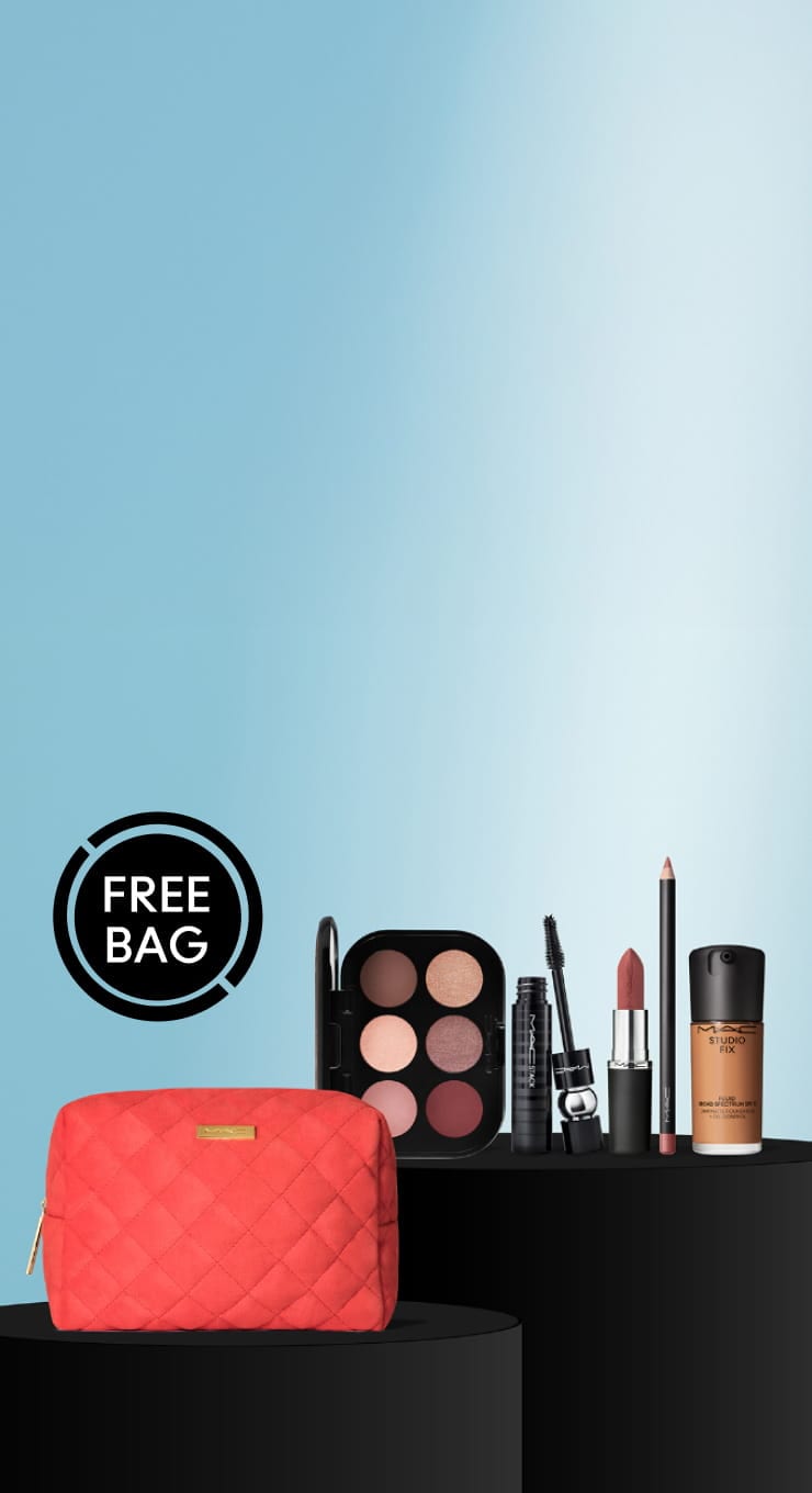 red makeup bag and products on blue background